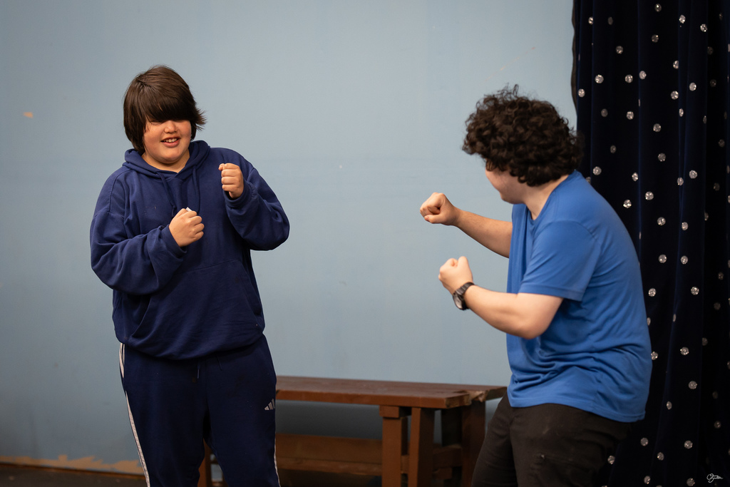 students acting in theater class