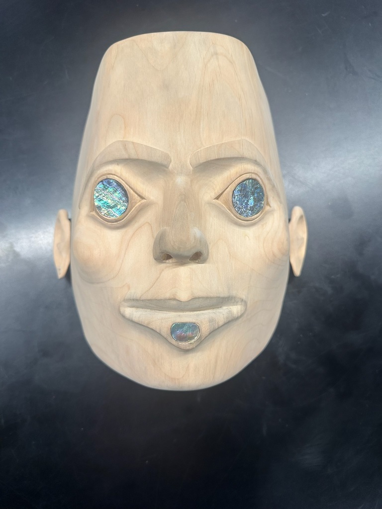carved mask with abalone eyes