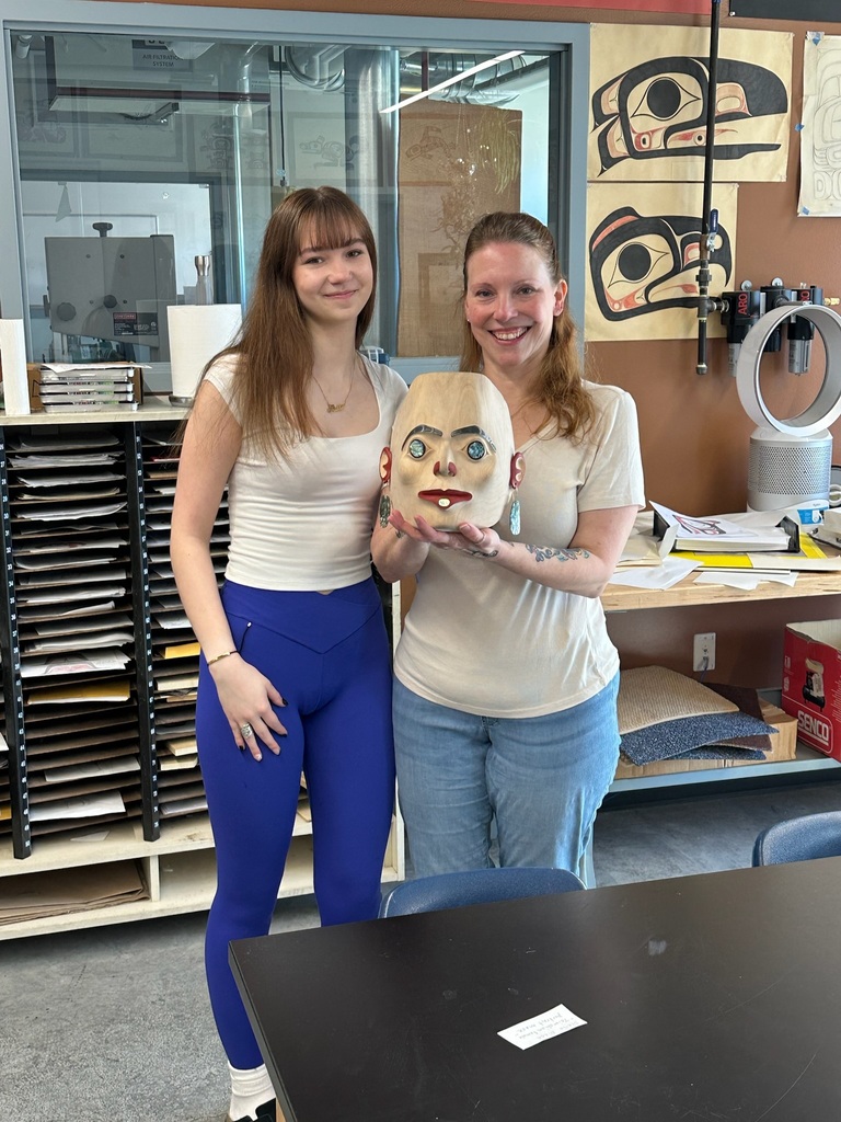 student and mother holding a mask