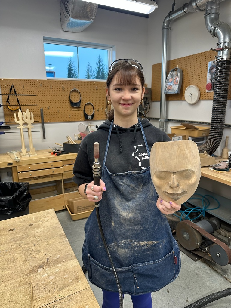 student holding carving tools