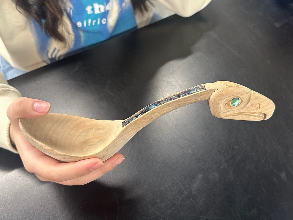 carved wooden spoon with an eagle head