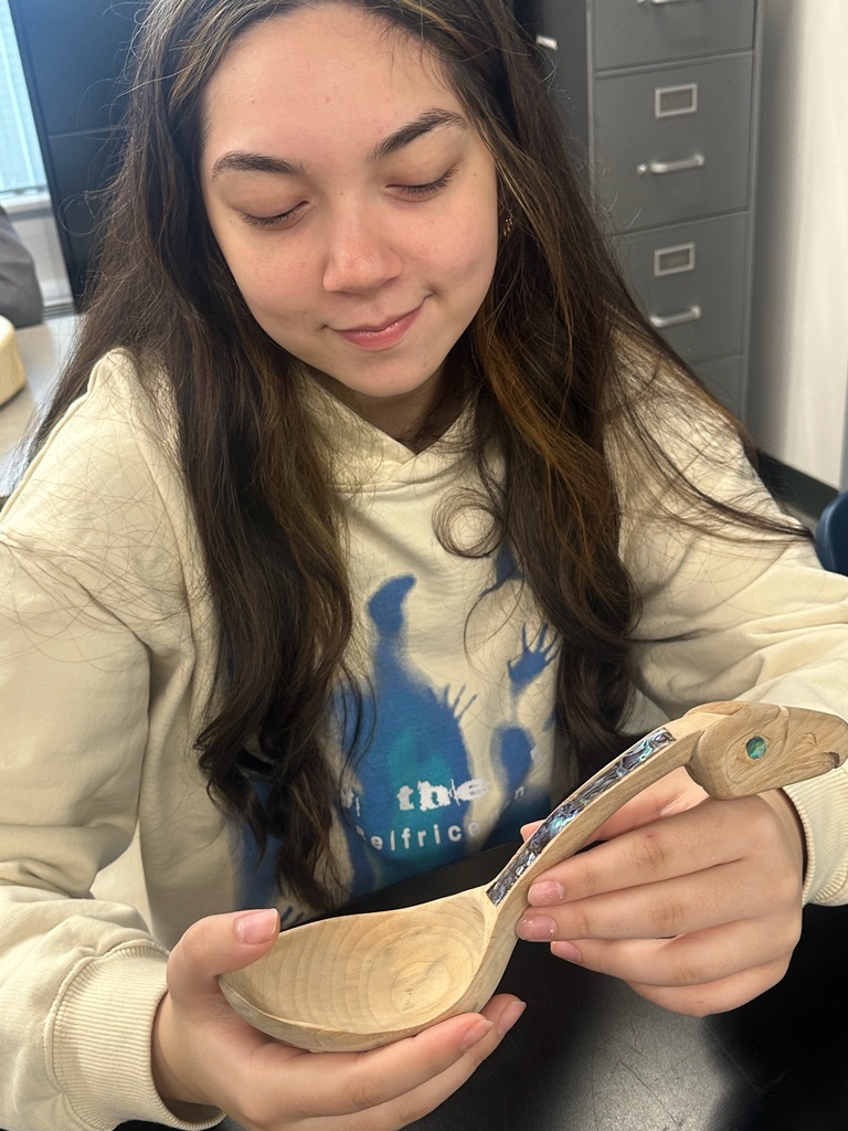 student holding a wooden spoon