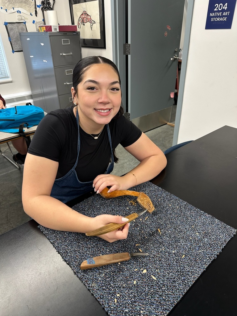 student carving a spoon