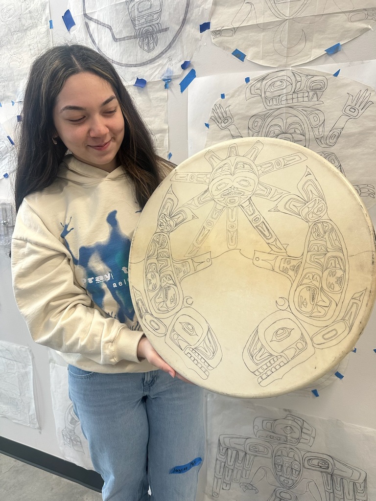 student holding a drum