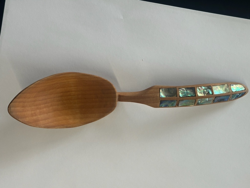 carved wooden spoon with abalone inlay