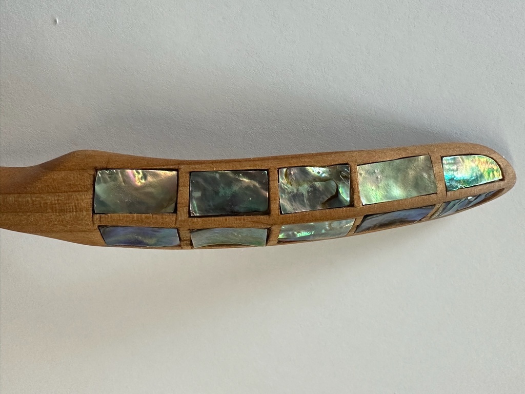 carved wooden spoon with abalone inlay