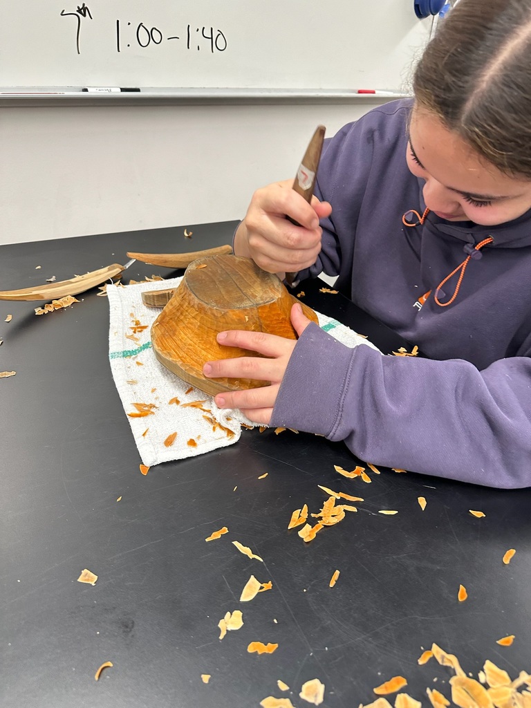 student carving in a classroom