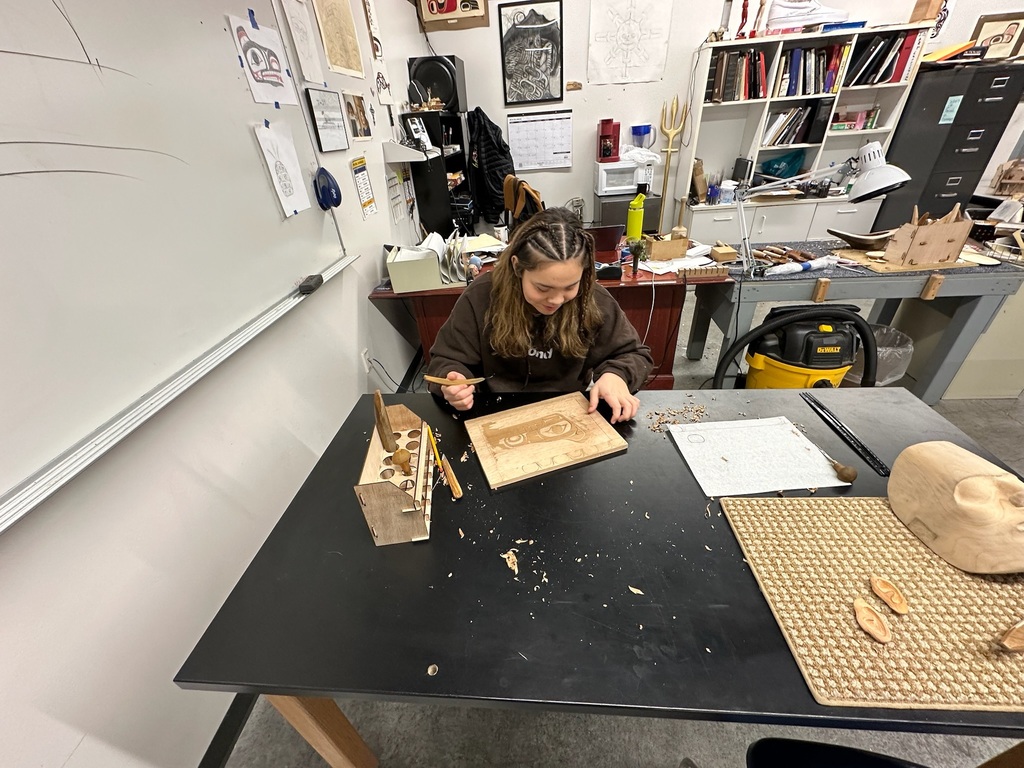 student carving in a classroom