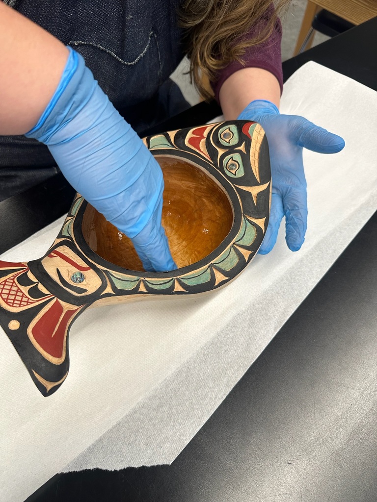 student working on painted halibut bowl