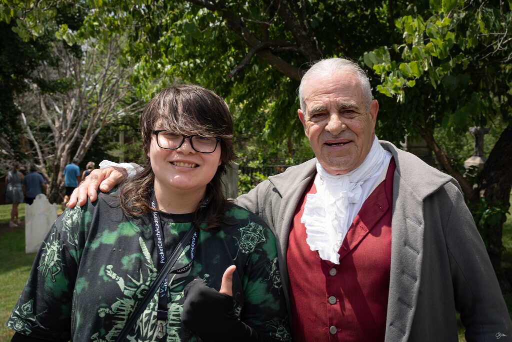 student posing with a old time actor
