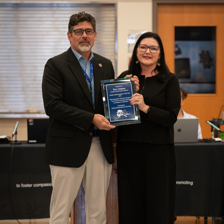 man and woman holding award
