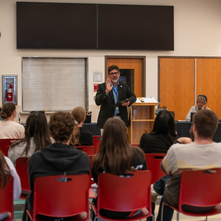 man presenting in front of a small audience