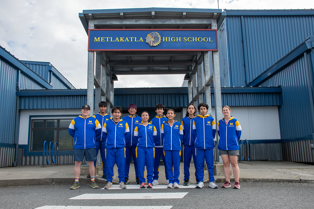 students in uniforms in front of school