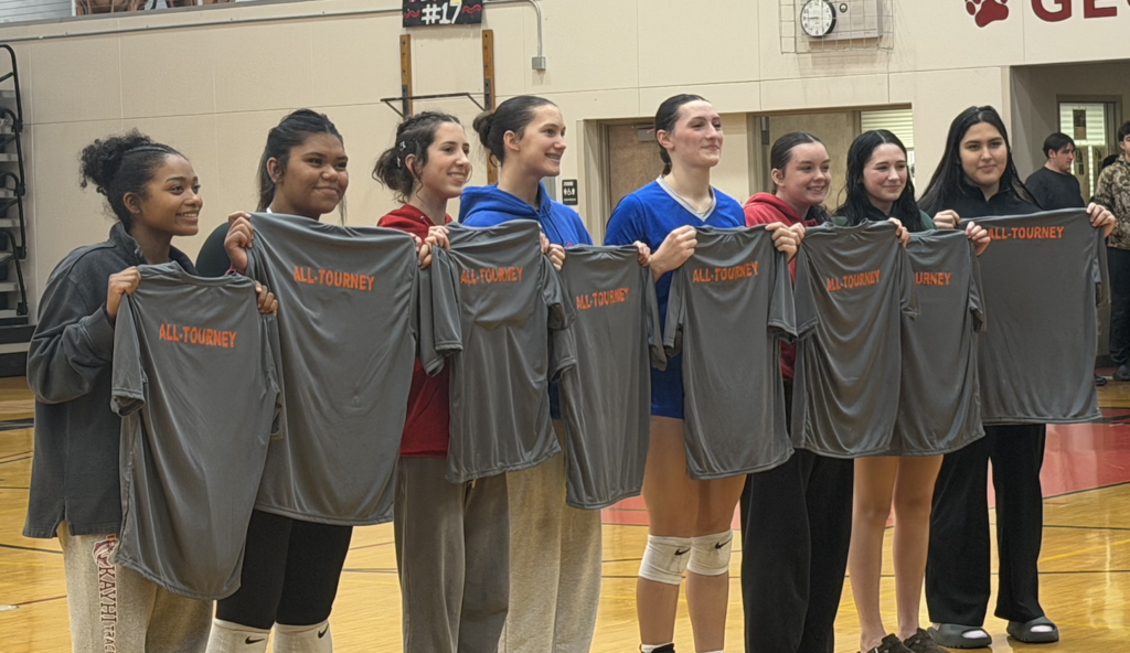 girls holding up all-tourney shirts