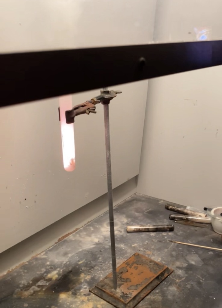 graduated cylinder with flame