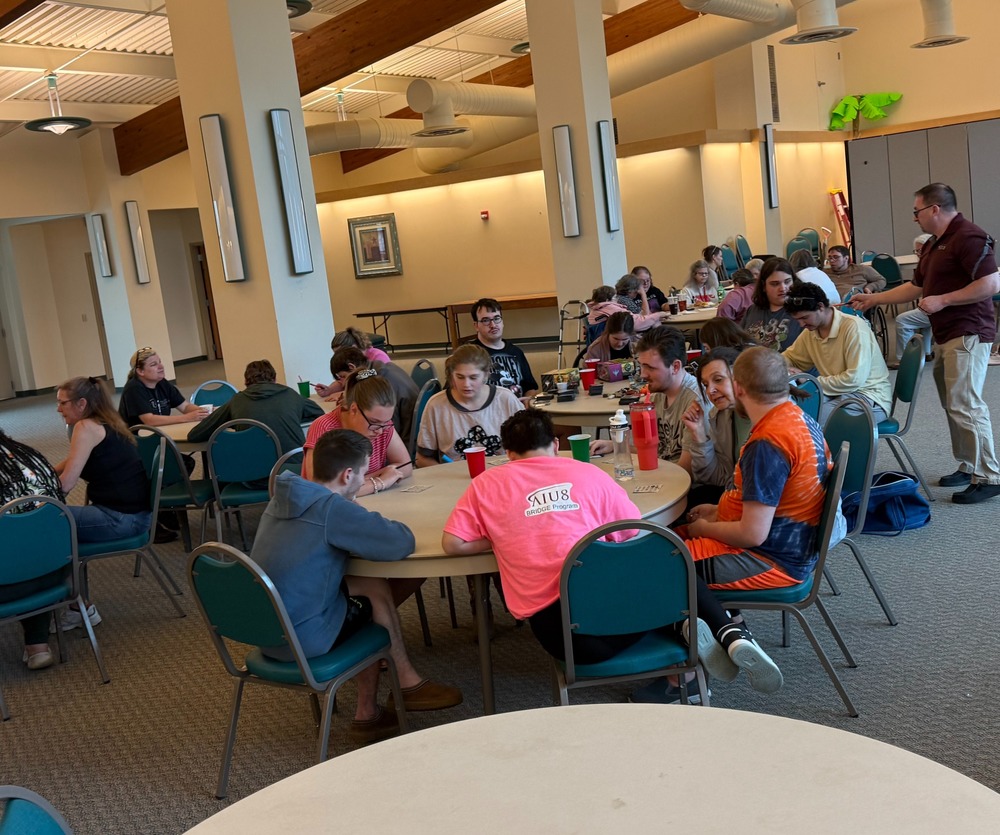 Students at tables in a large room