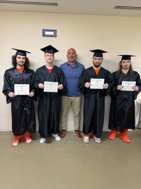 four graduates and a teacher