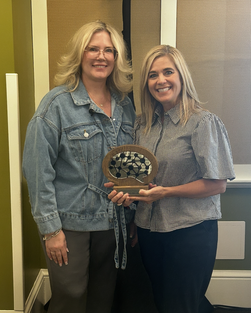 two women with an award