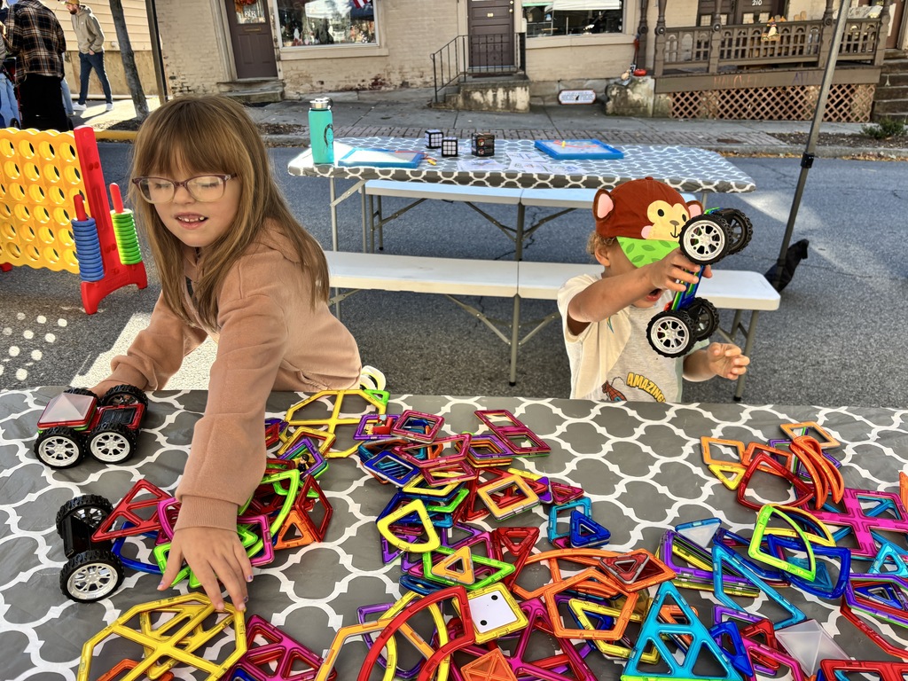 two kids building with magnet blocks
