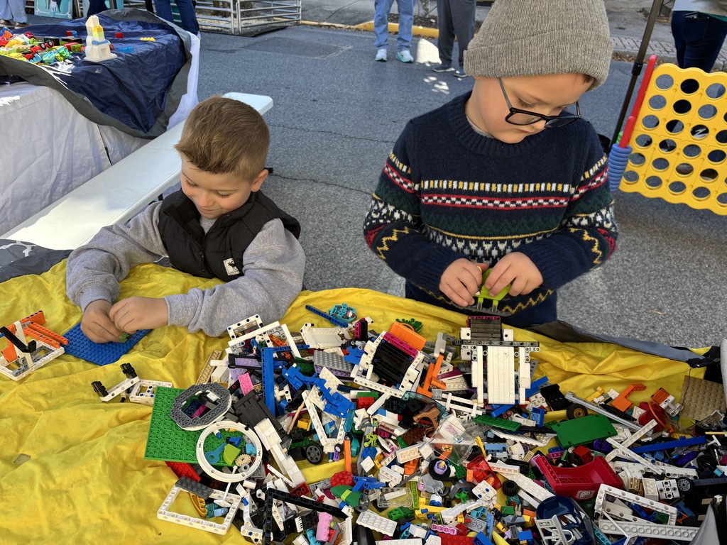 two kids building with legos