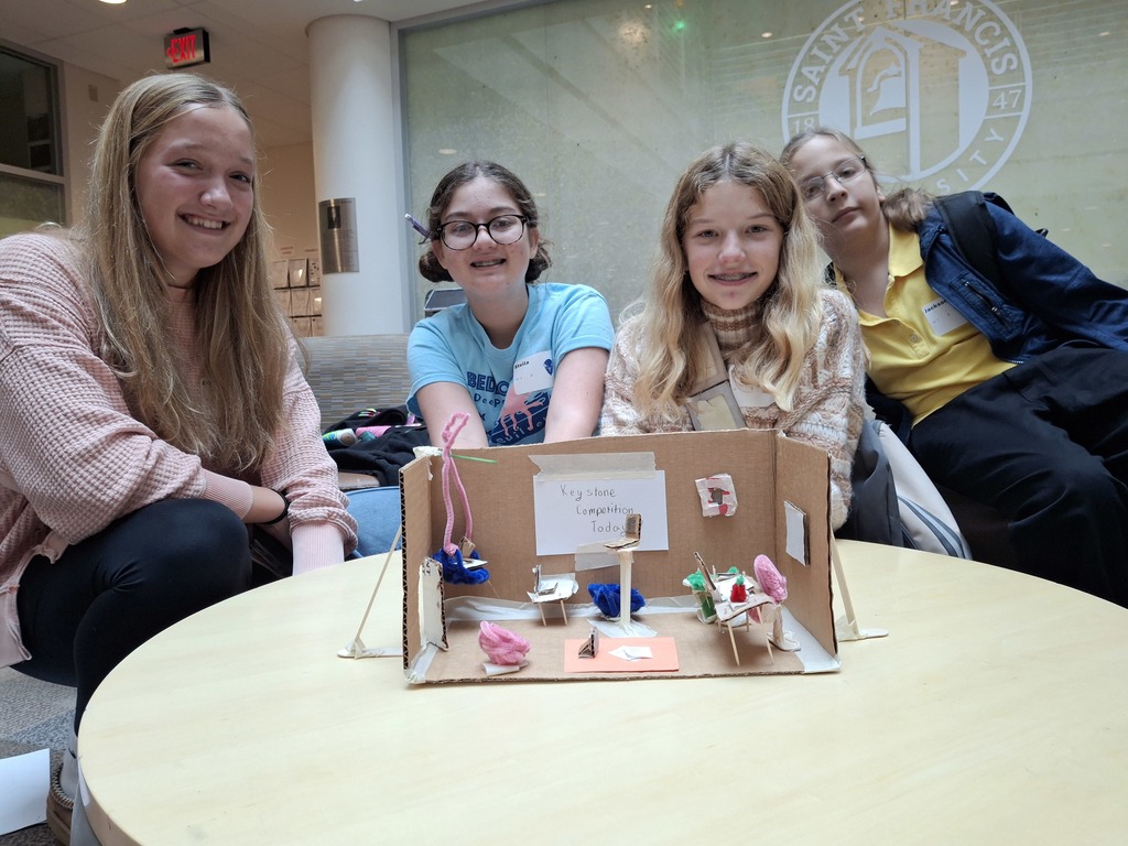 four students showing a project they created