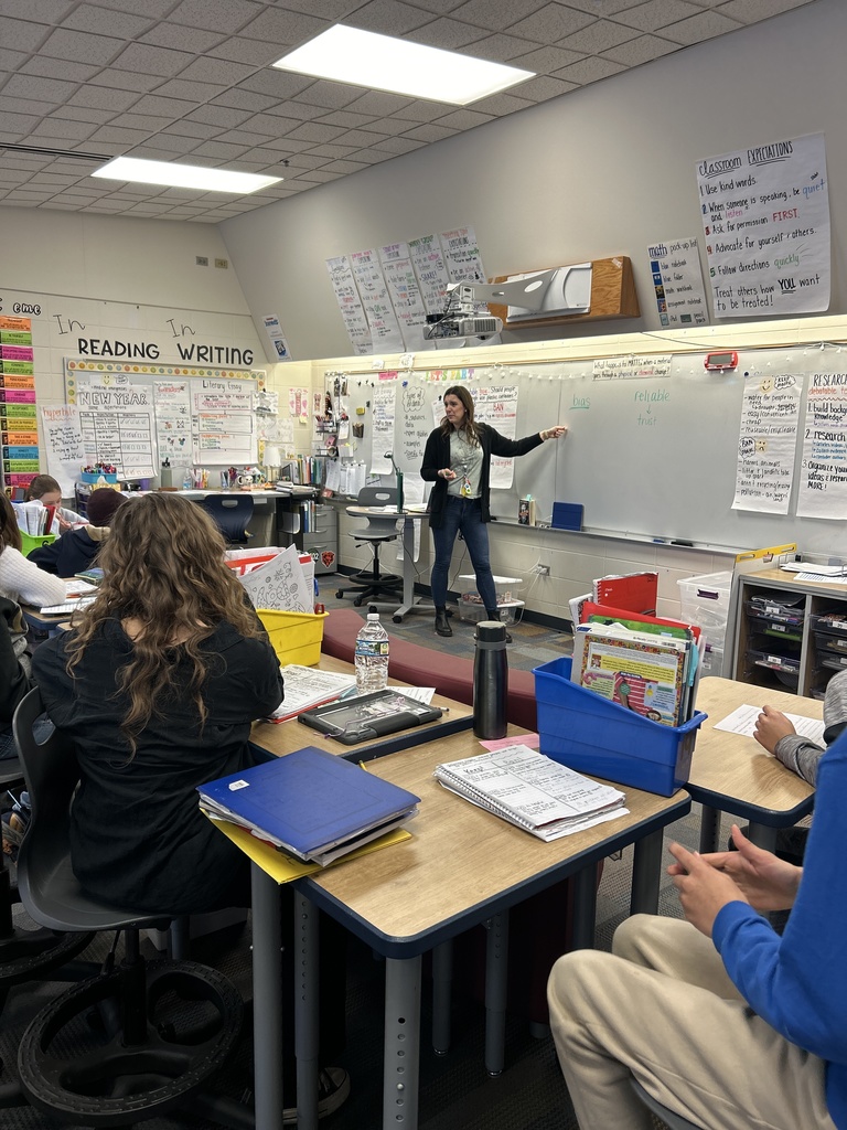 Mrs. Smith standing in the front of the class teaching.