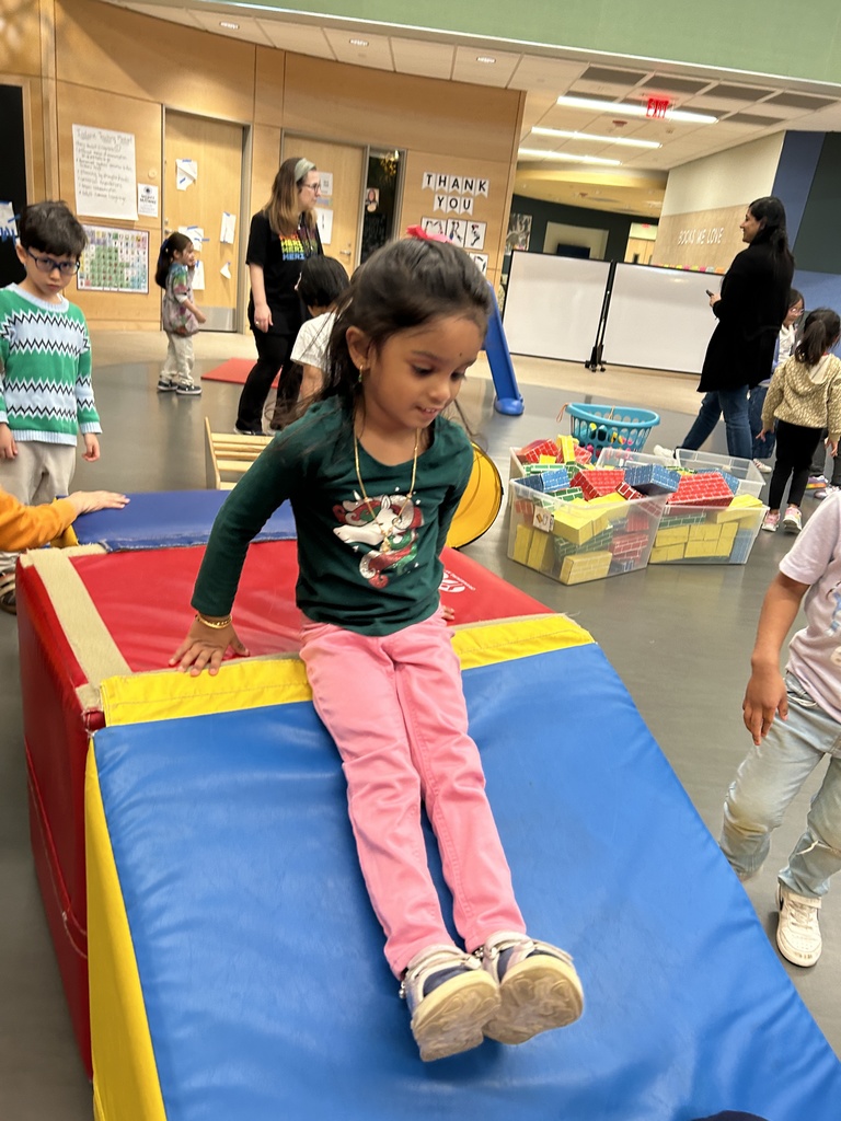 Student sliding down a ramp.
