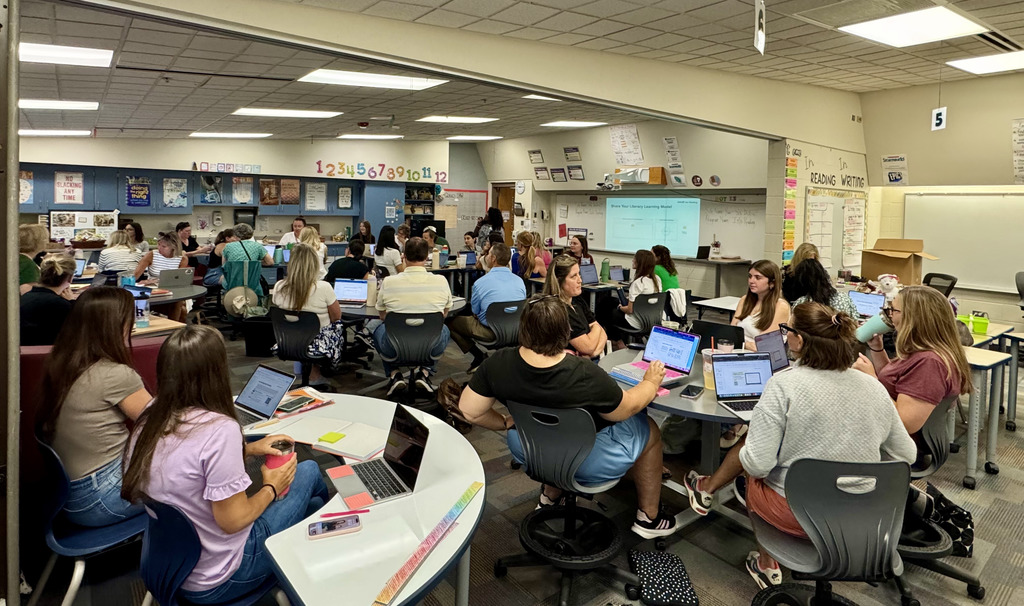 Teachers sitting and listening to presentation.