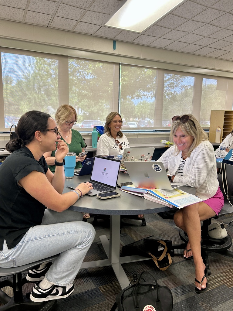 teachers sitting at a table.