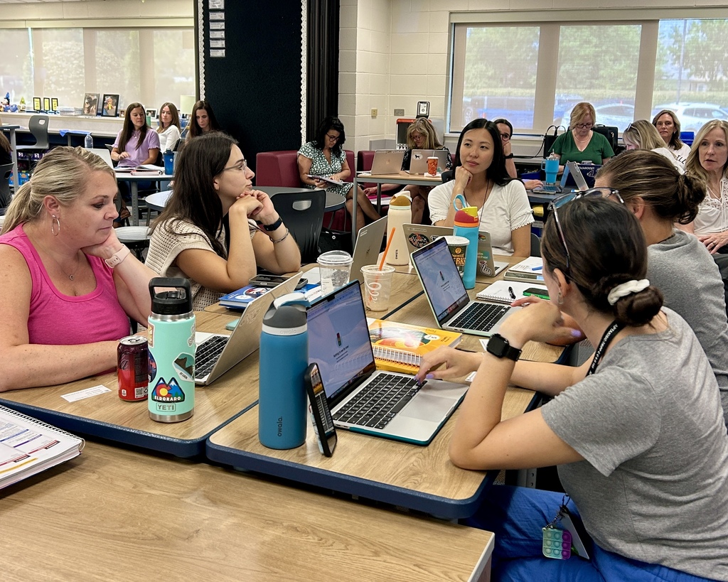 teachers sitting at a table.