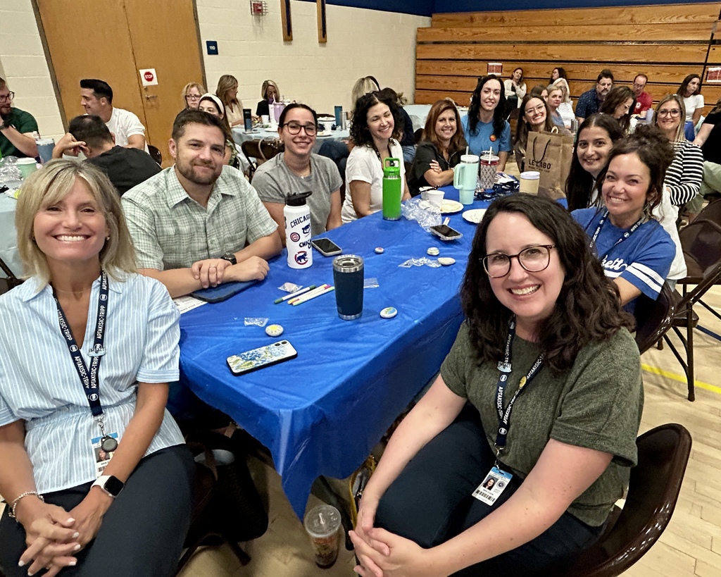 Staff sitting and smiling together.
