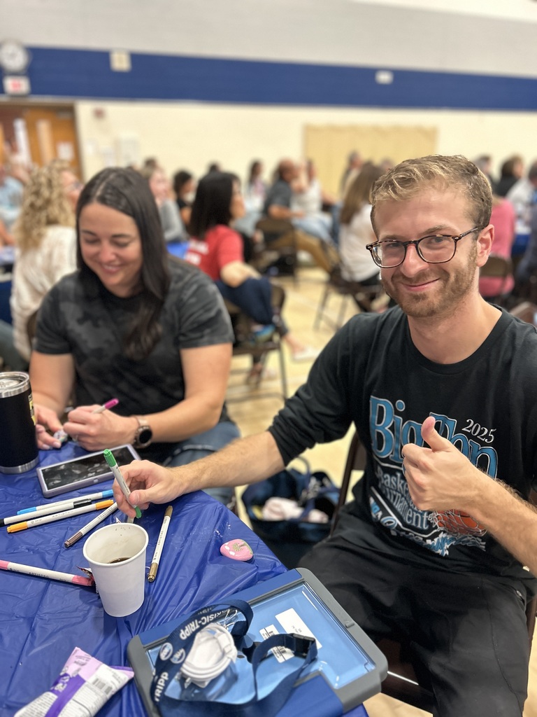 Teachers painting rocks.
