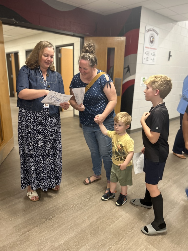Family looking at a map with a staff member.