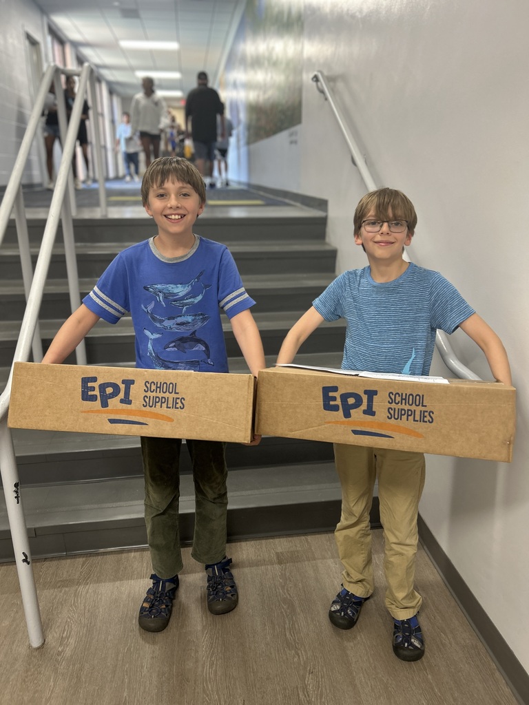 Students holding supply boxes.