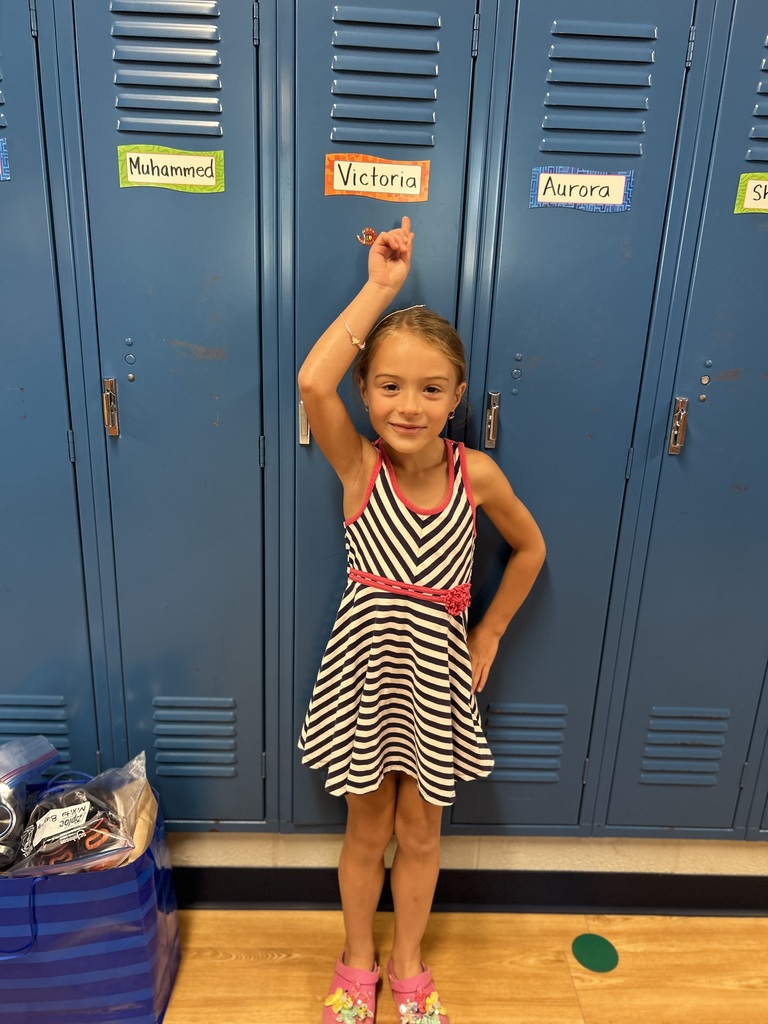 Girl pointing to her locker.