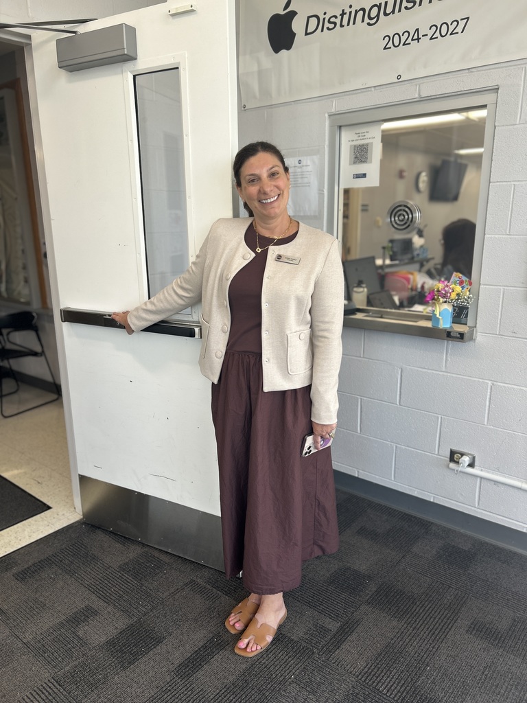Principal holding the door for famillies.
