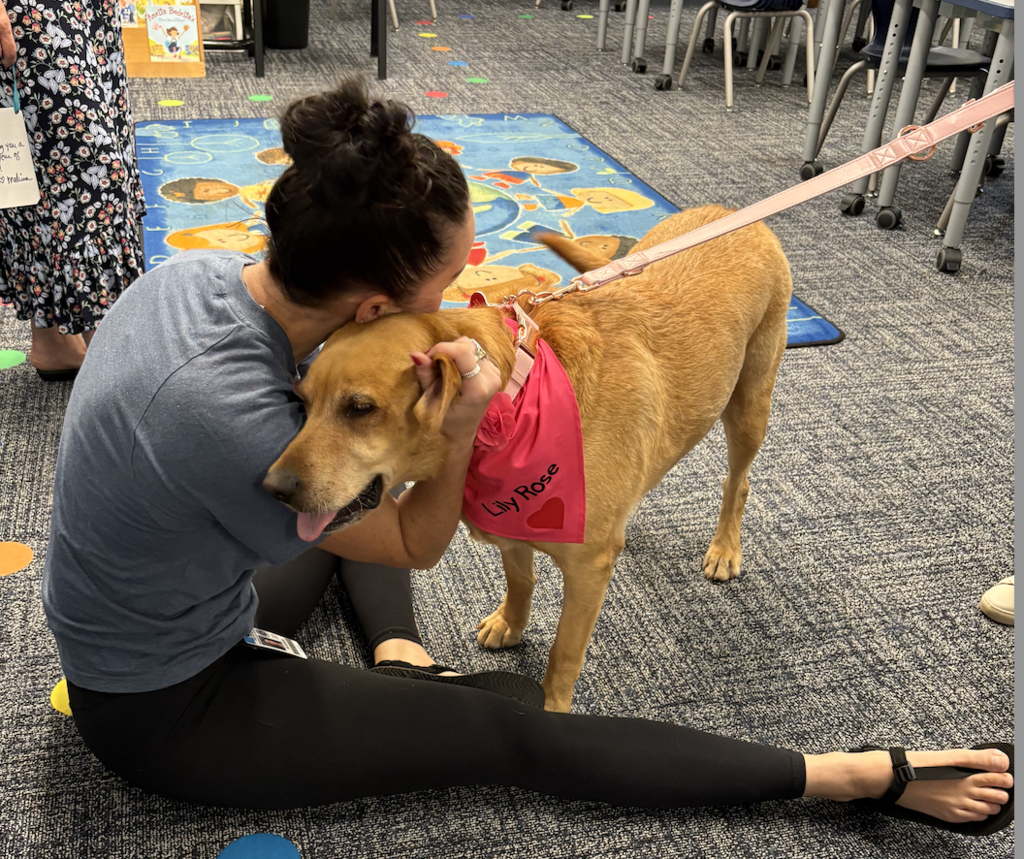 Teachers petting a dog.