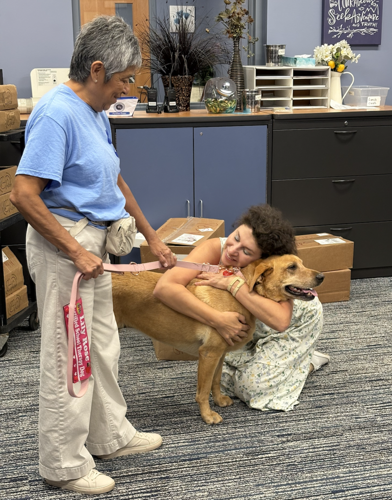 Teachers petting a dog.