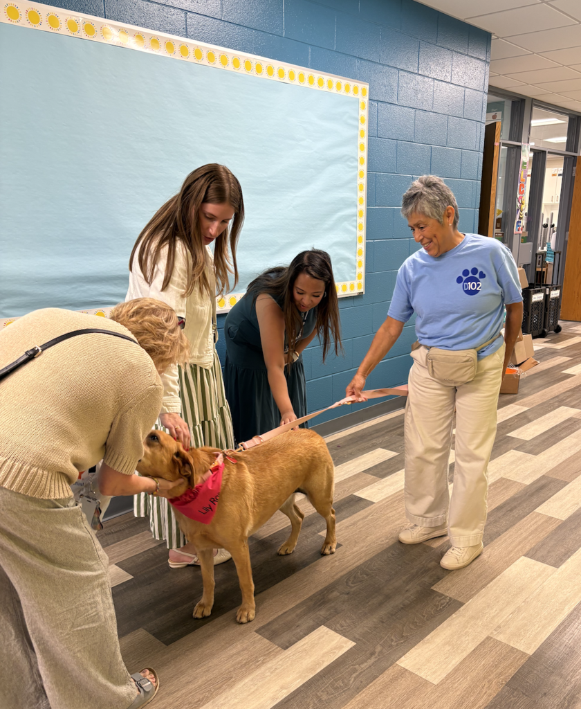 Teachers petting a dog.