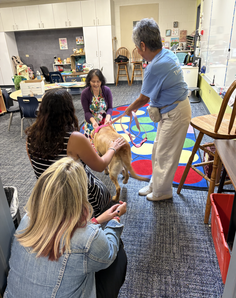 Teachers petting a dog.