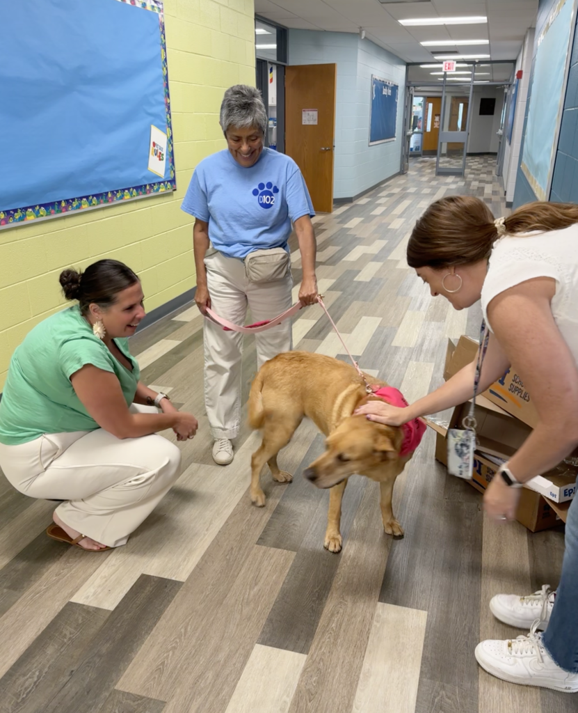 Teachers petting a dog.