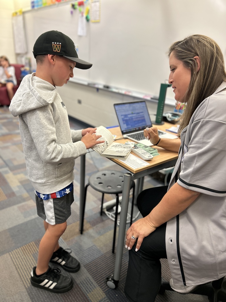 Student reading with teacher.