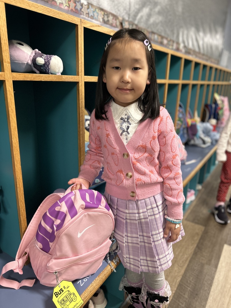 Student standing by her cubby.