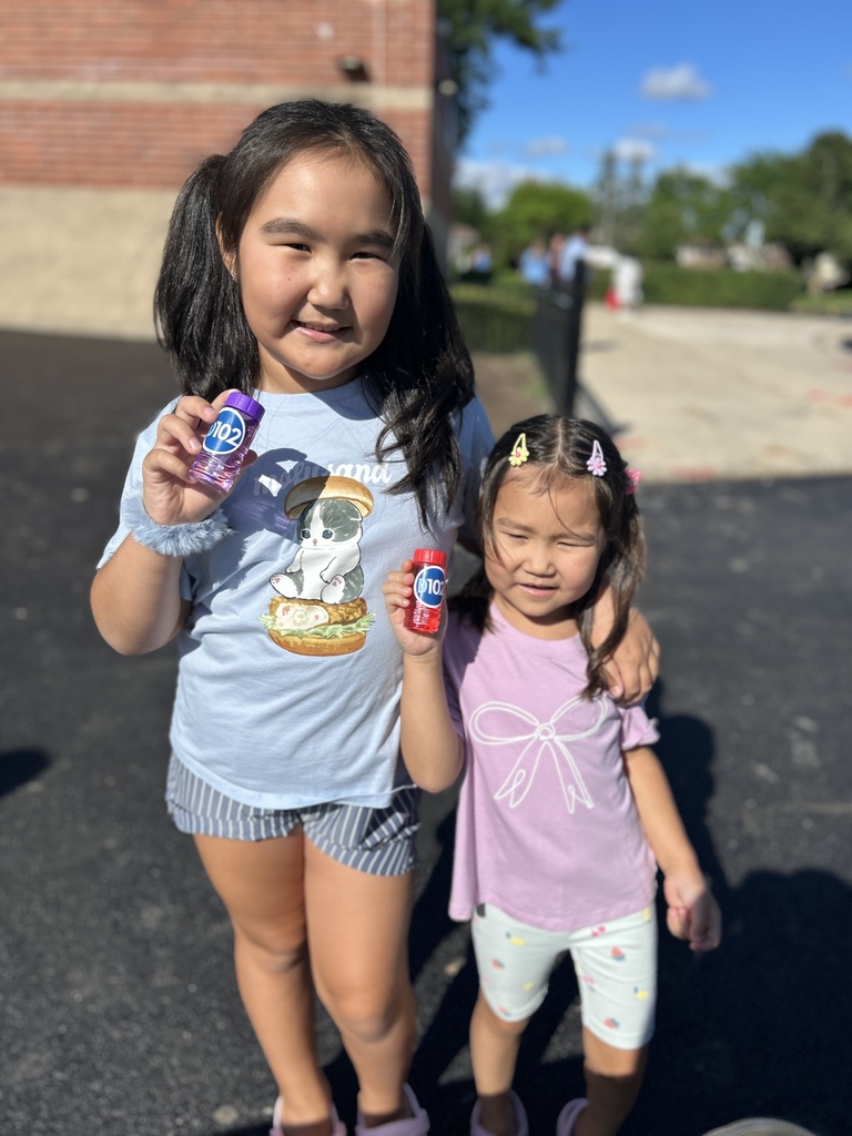 Two girls holding bubbles.
