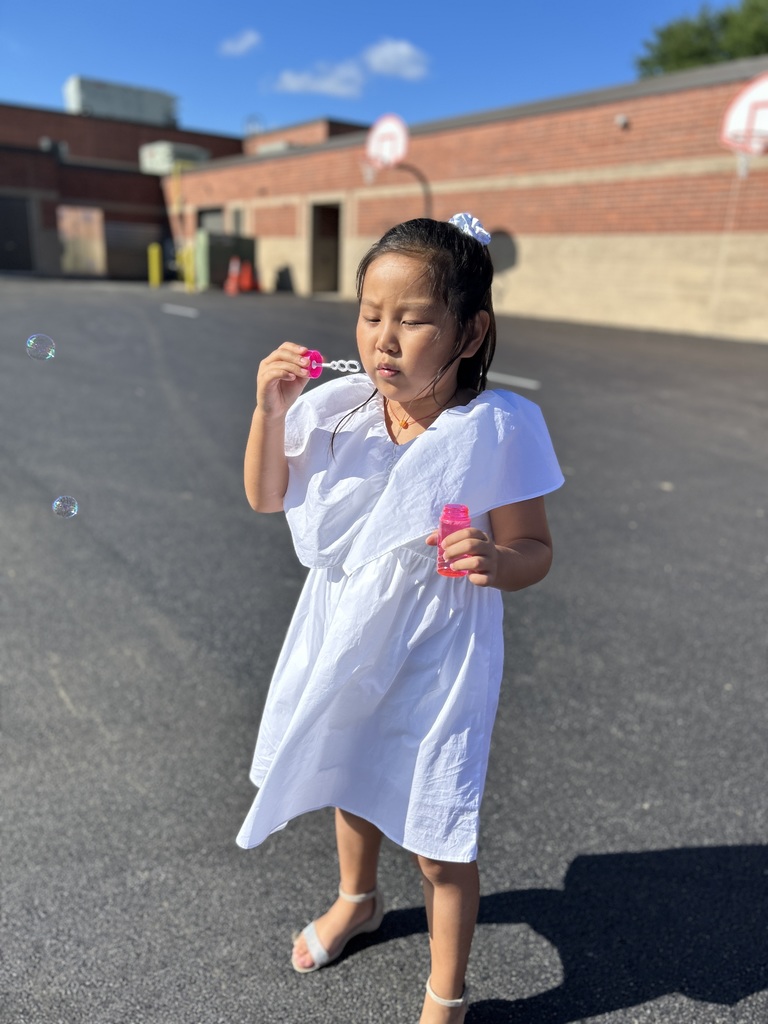 Girl blowing bubbles.