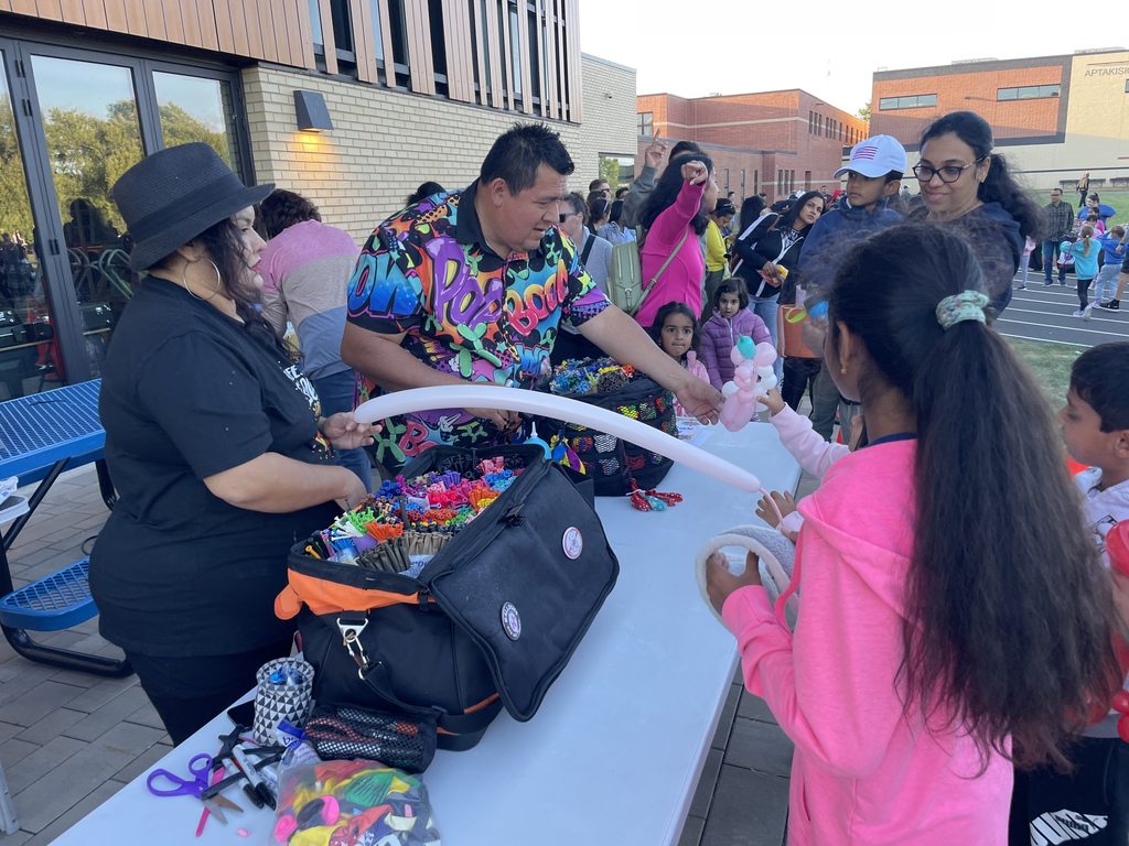 Students getting a balloon animal.