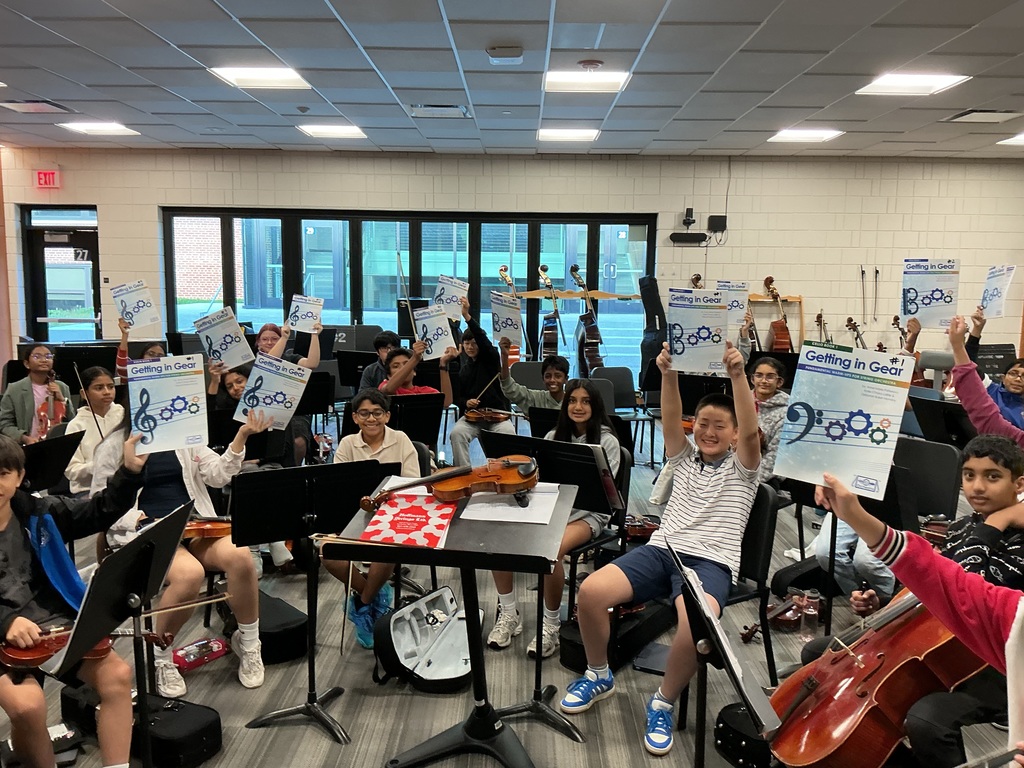 Students holding up new music books.
