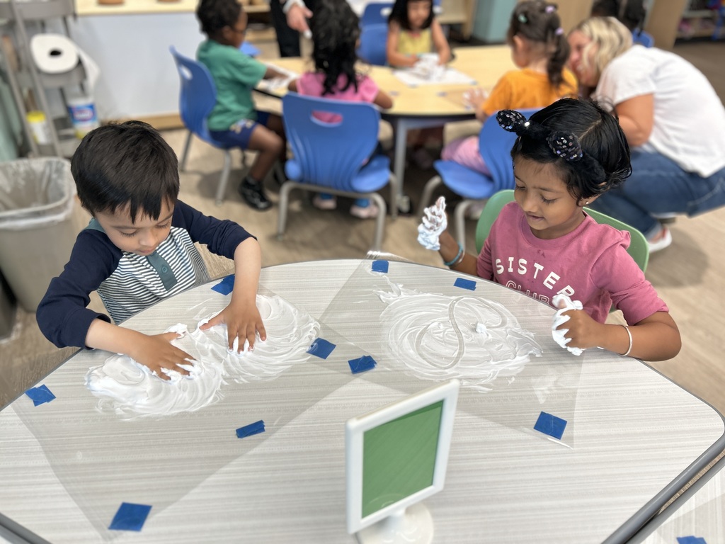 Students working at the table with shaving cream.