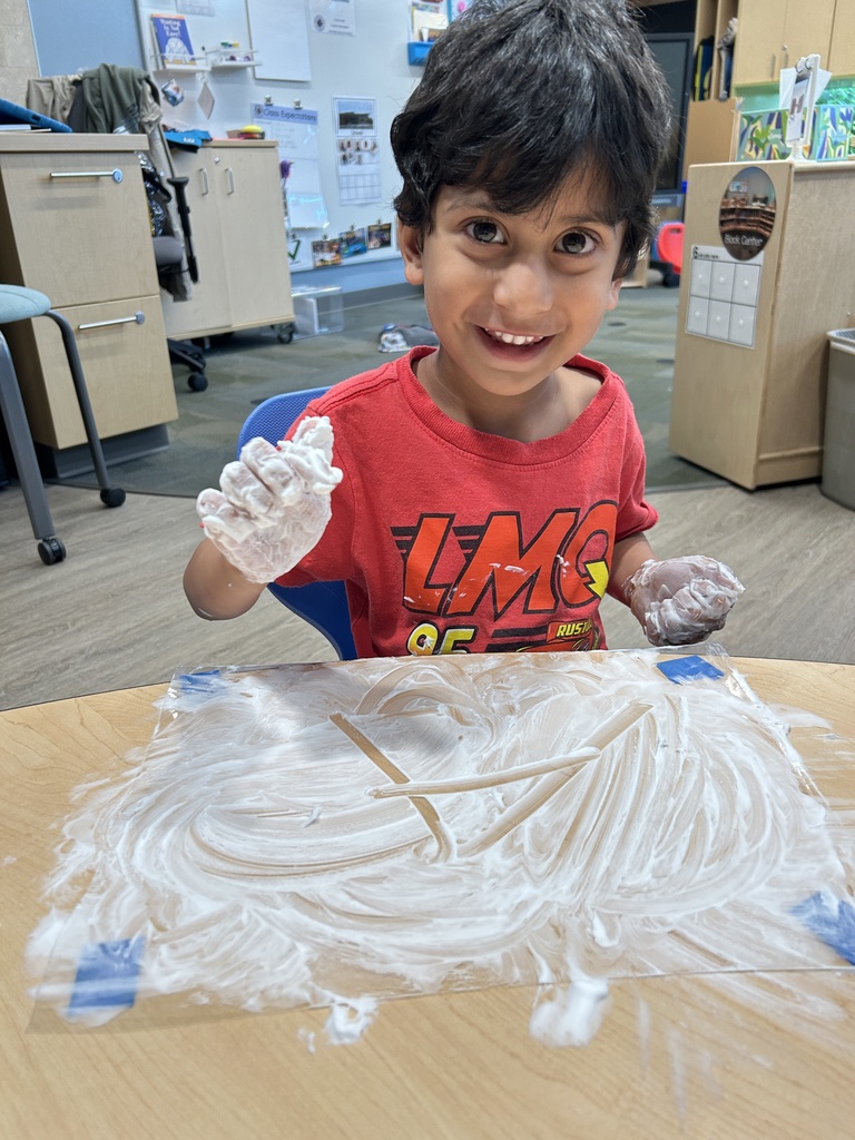 Student sitting at his desk with shaving cream.