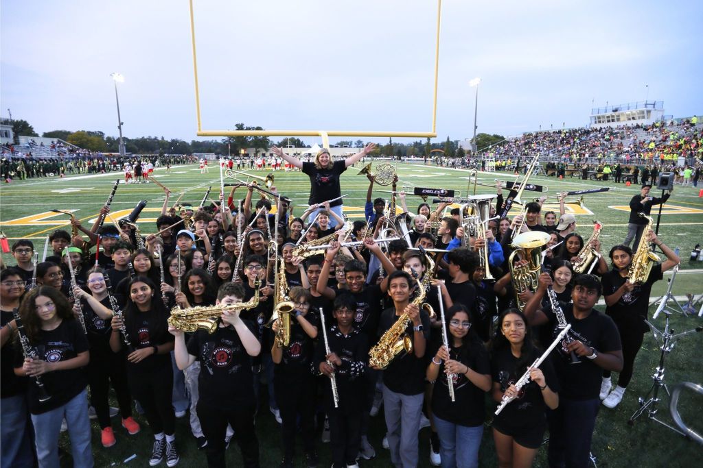 Students cheering on the football field.